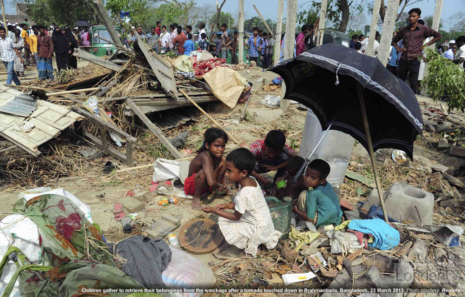 Bengali children trying to salvage wrecks from tornado in Brahmanbaria, Bangladesh on 23 March 2013